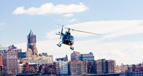 Helicopter flying over city skyline, representing helicopter boss