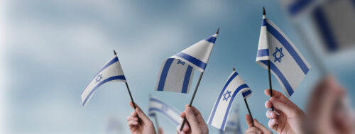 People holding Israeli flags; donors fight antisemitism