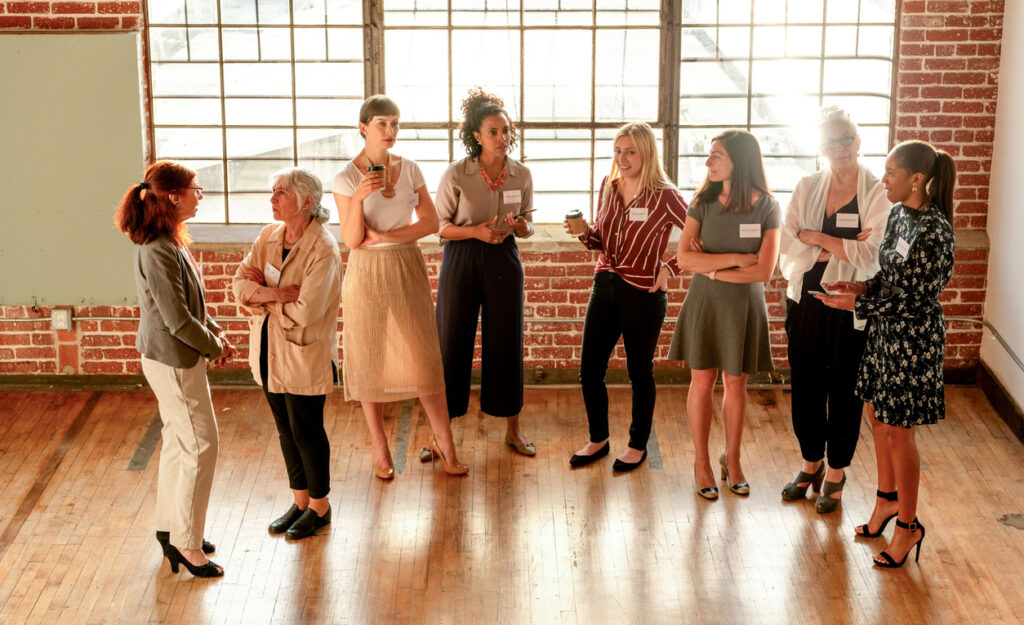 Women networking in sunlit loft.