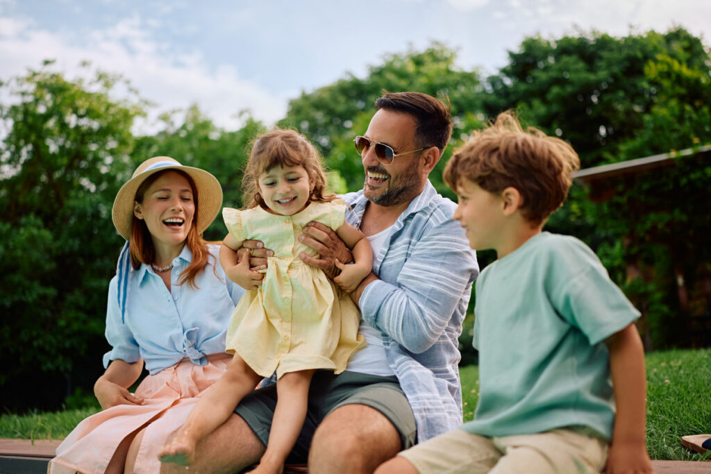 Happy parents having fun with their kids on summer holiday.