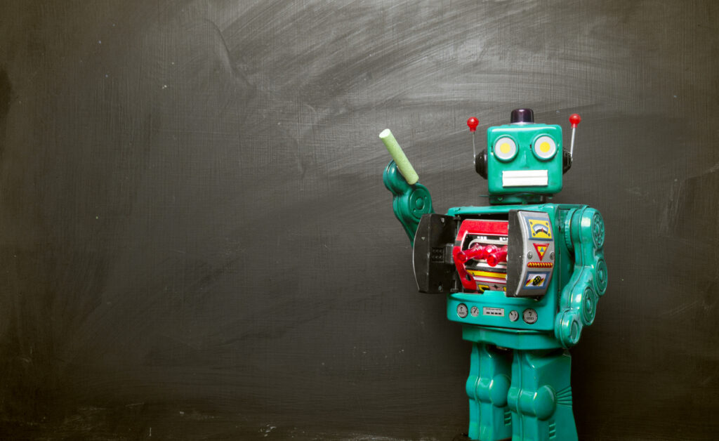 Big cyan blue robot toy teaches his class , blackboard and copy space